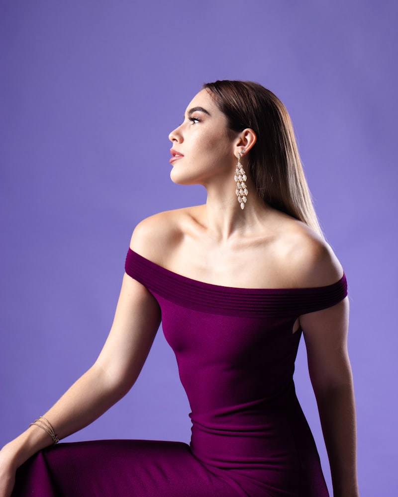A woman in an off-shoulder plum evening dress