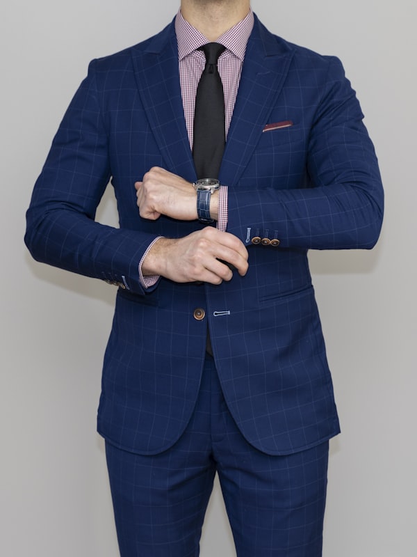 Man wearing a tailored navy two-piece suit
