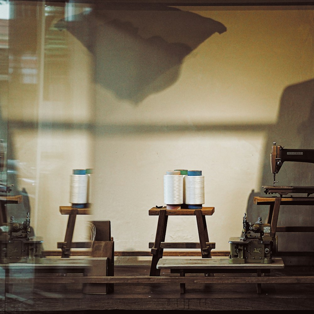 An artisan's hands hand-stitching a wool coat in the atelier