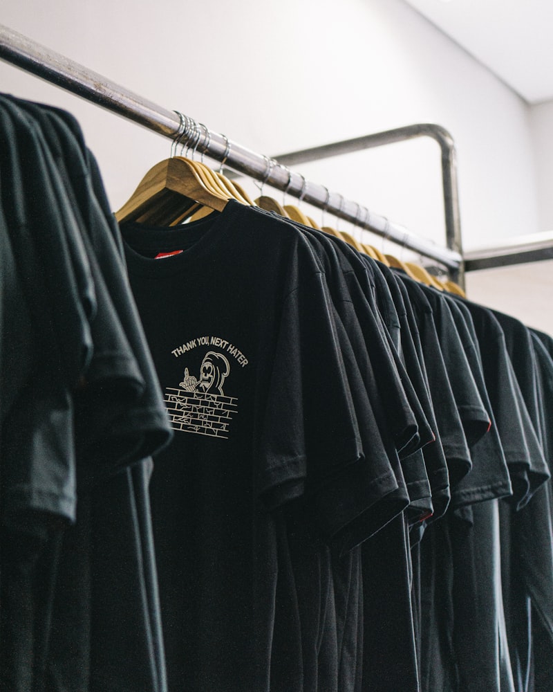 A rail of faded-black 90s graphic tees