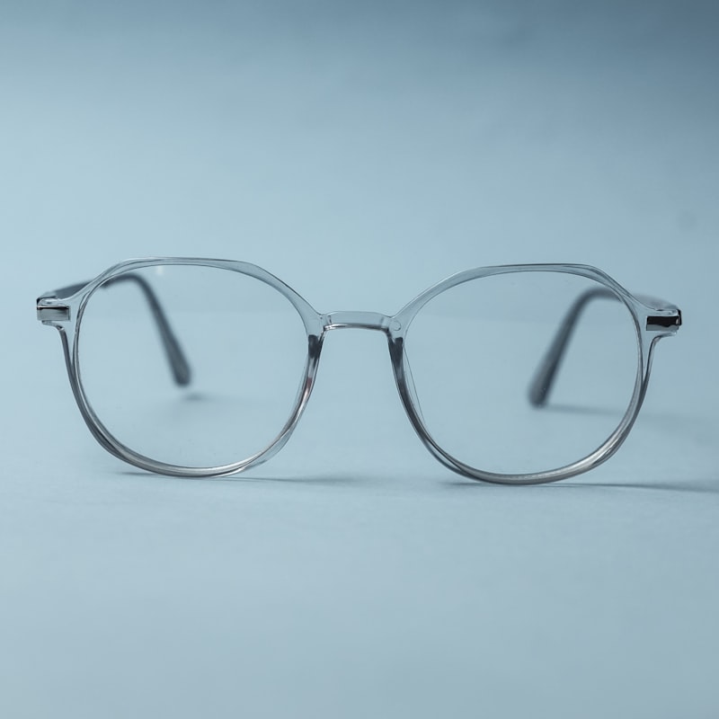 A crystal round optical frame on a soft grey surface