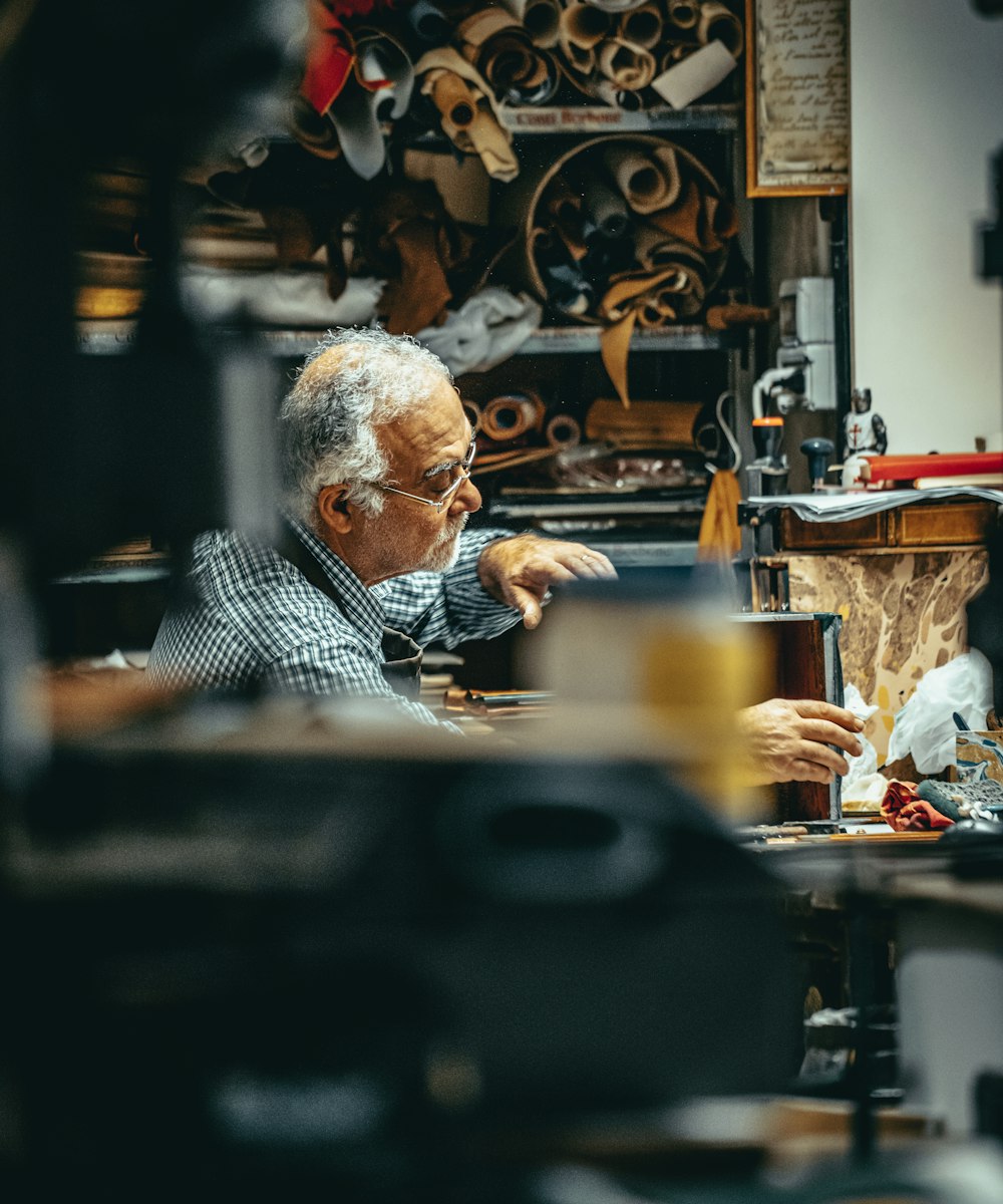 A leather artisan at work in his Corvelle workshop