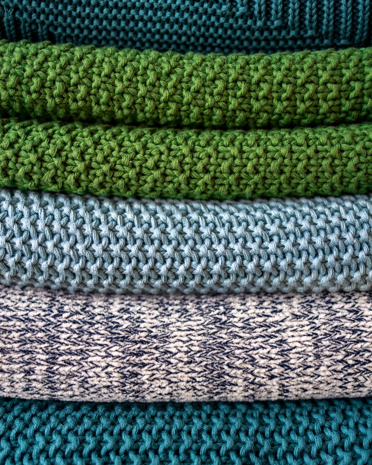 Folded lambswool and merino knits in green and grey tones