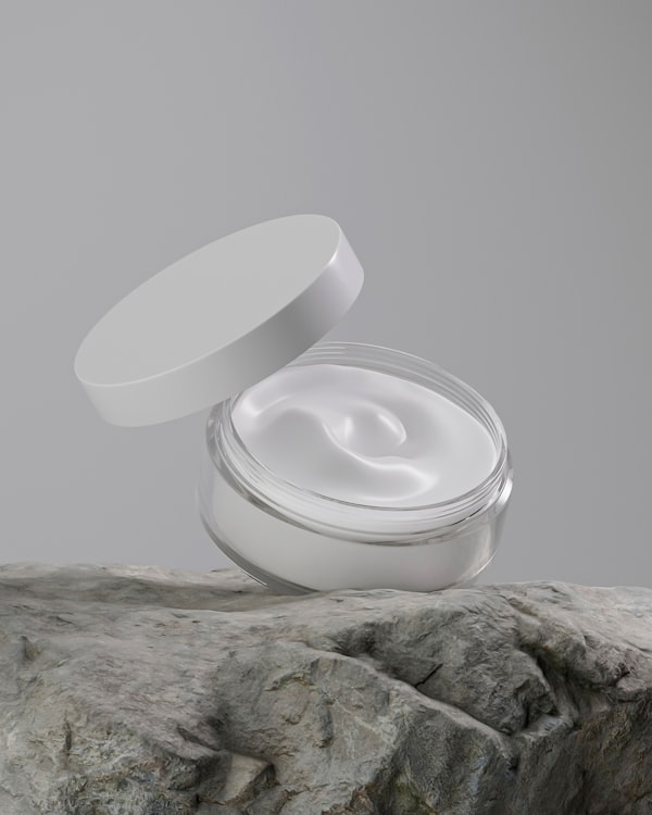 An open jar of moisturiser on a stone