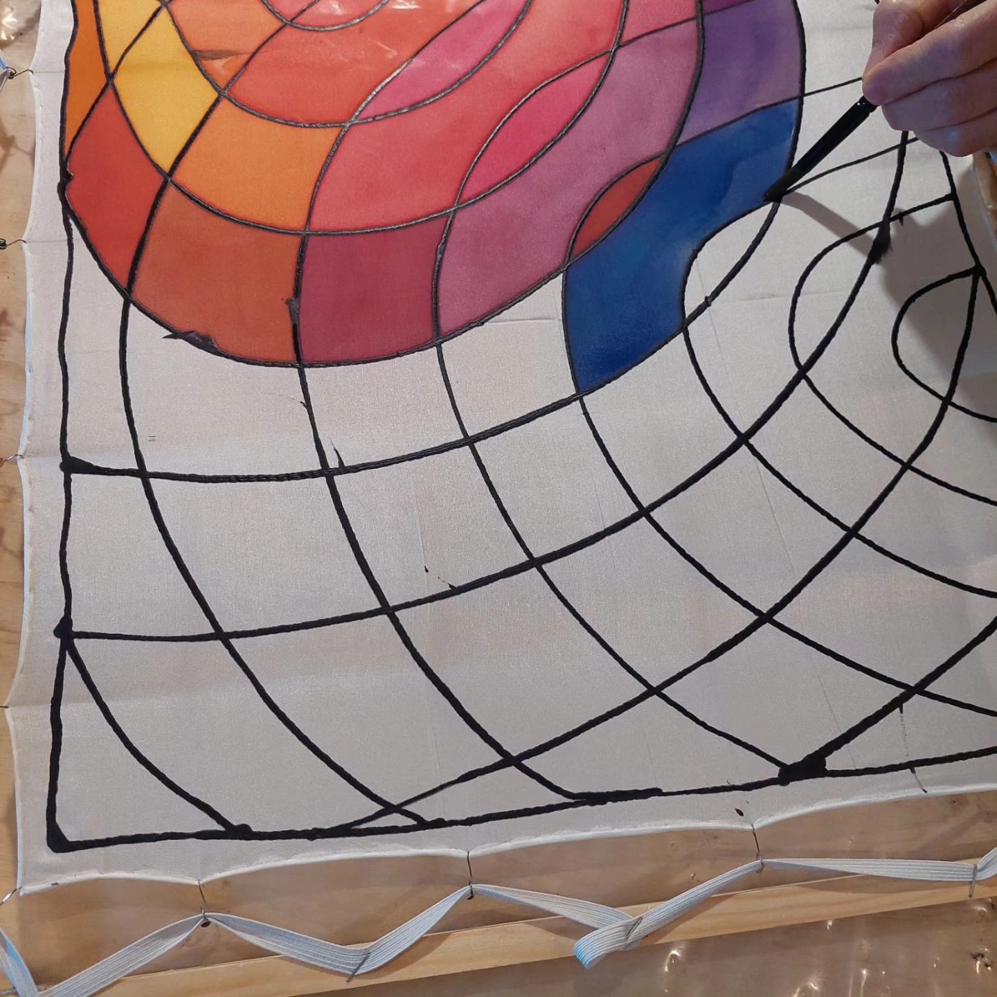 A one-off pattern being painted onto silk by hand
