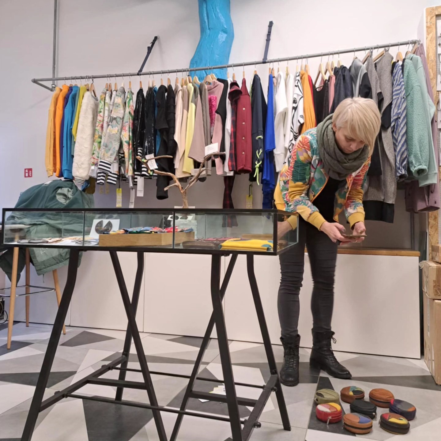 The designer at work over the big table in the atelier