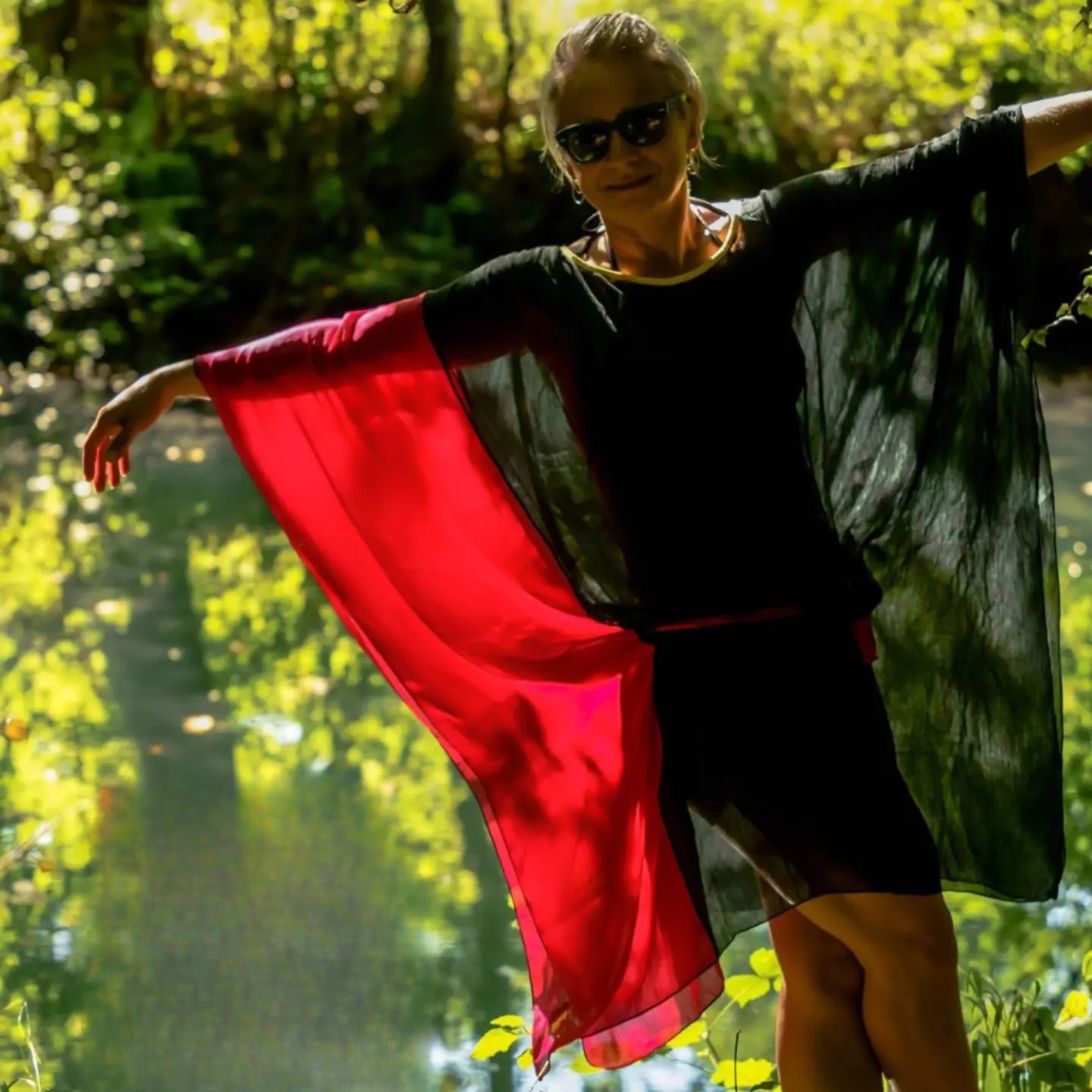 The Rujana kaftan catching the sun, red fabric in motion