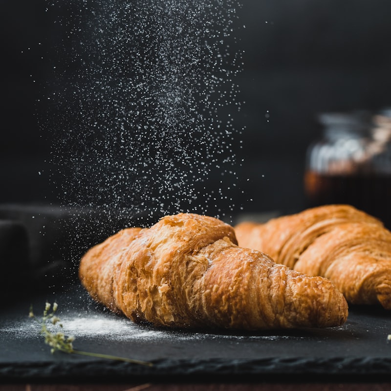 Golden almond croissant on a small plate