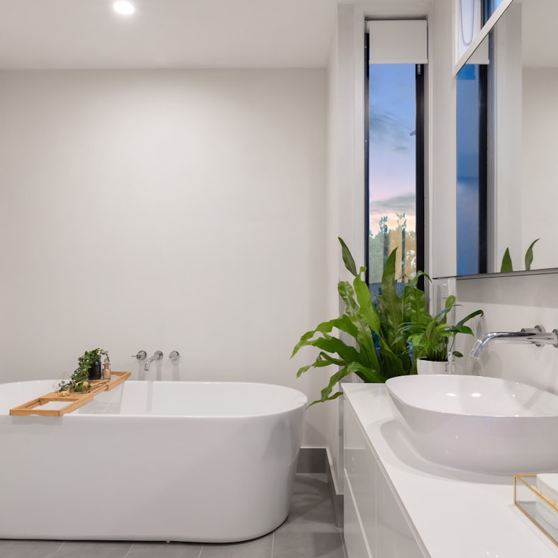 Spa-style primary bathroom clad in book-matched marble with a freestanding soaking tub.