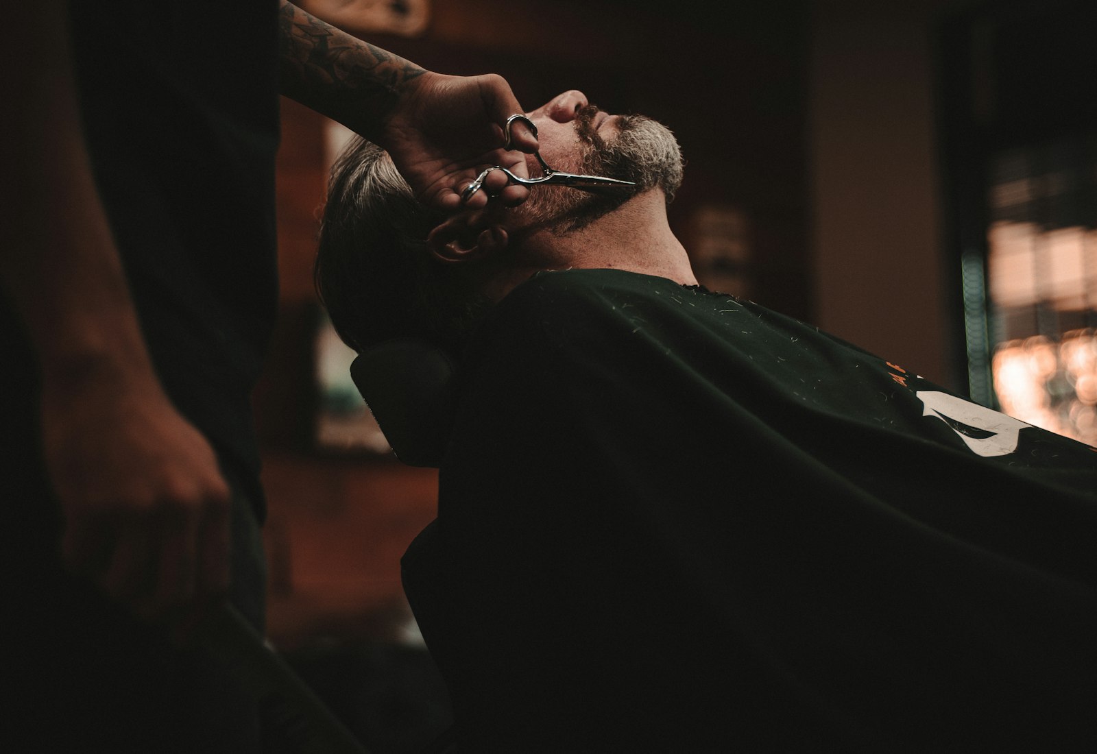 Barber giving a sharp fade in a vintage-styled barbershop chair