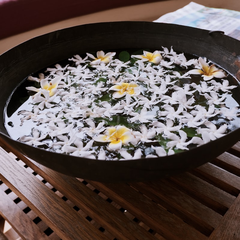 Stone basin with floating petals in a serene treatment room