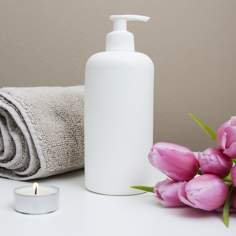 Folded warm towels and pump bottles of botanical oil