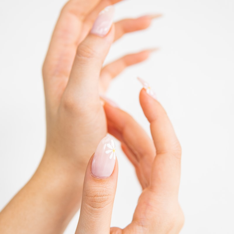 Pastel pink French tips with tiny floral accents