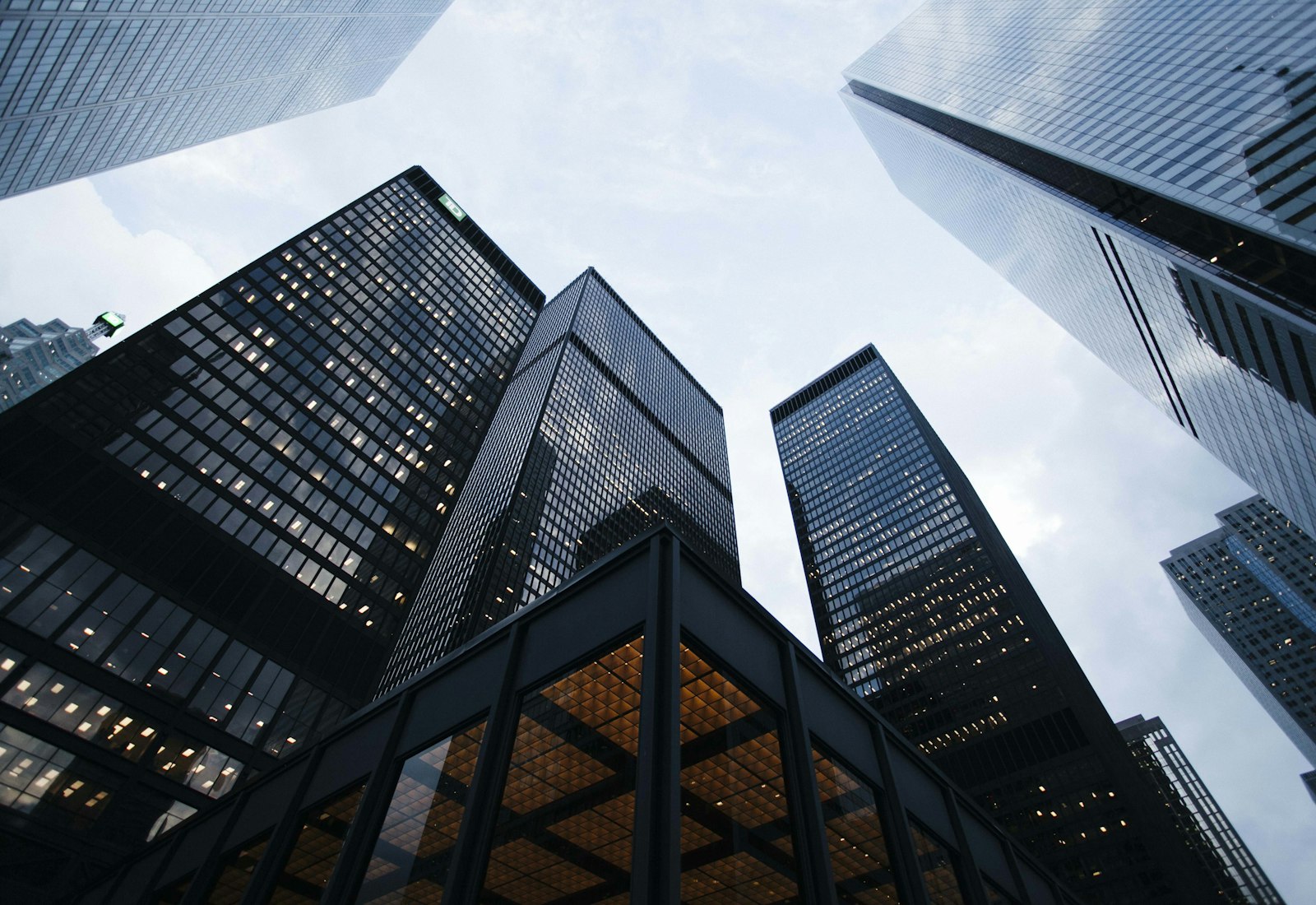 Looking up at the glass towers of a financial district at dusk