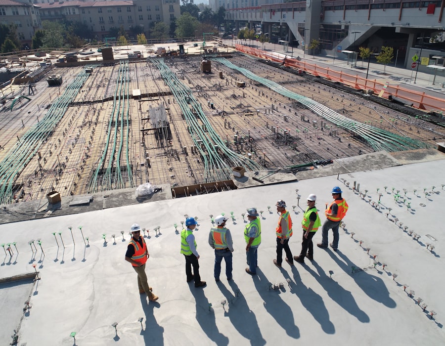 Ironside crew in hard hats and hi-vis surveying a large concrete pour from above