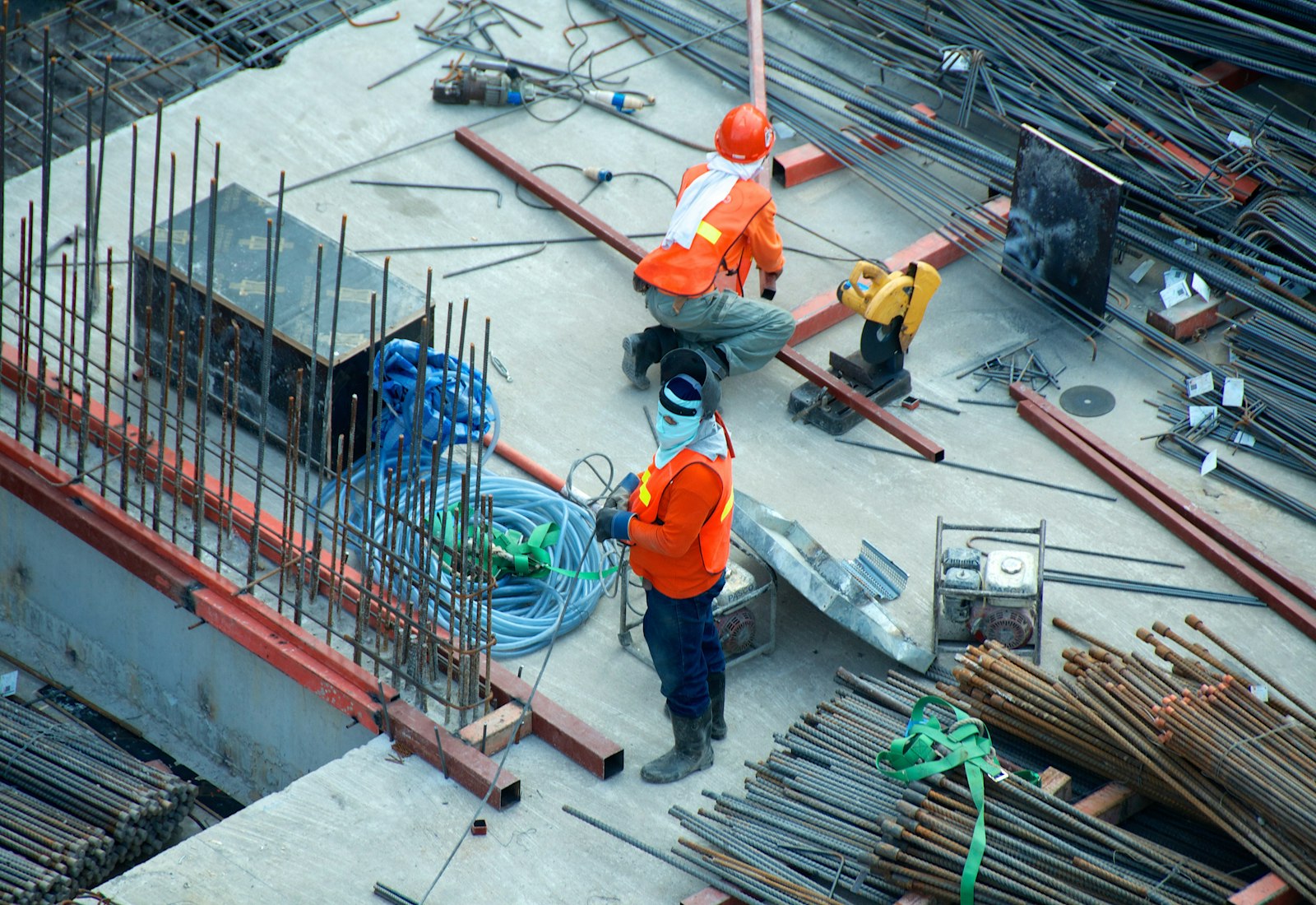 Ironside crew in safety gear working with rebar on an active commercial construction site