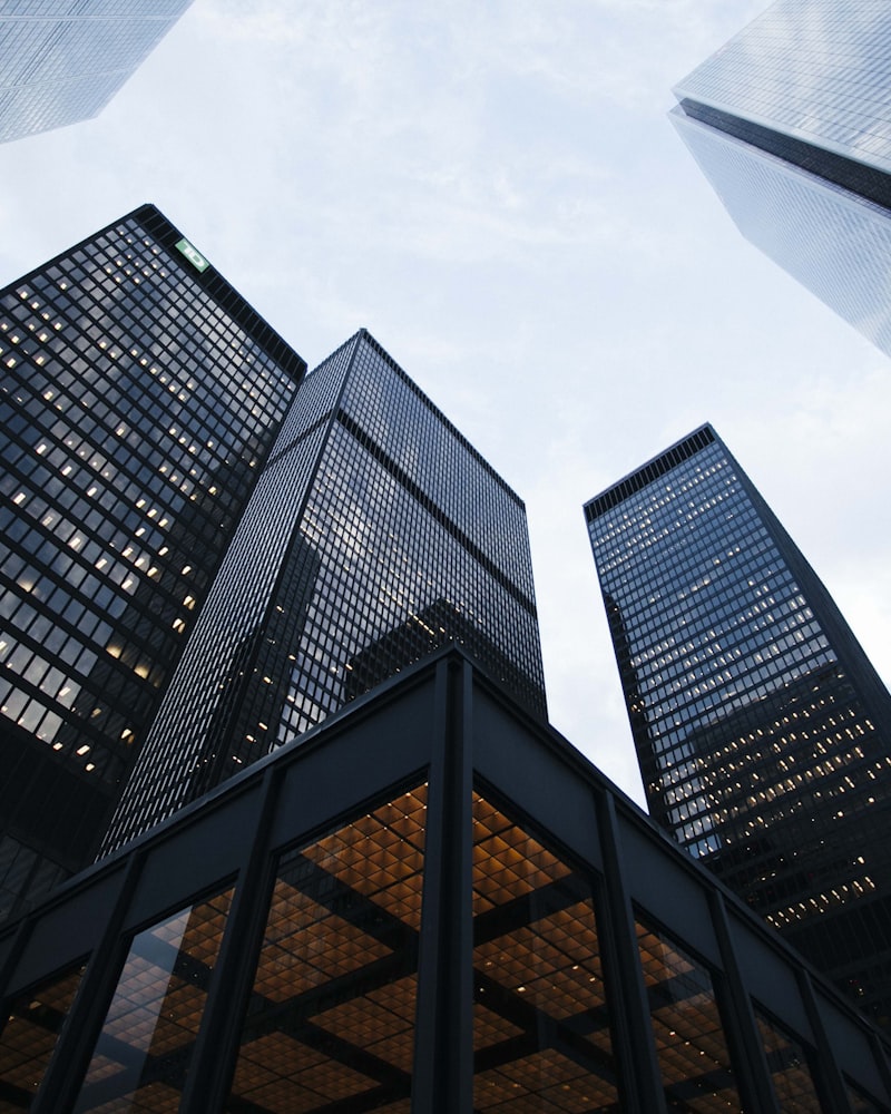 Cluster of finished glass-and-steel commercial towers shot from below