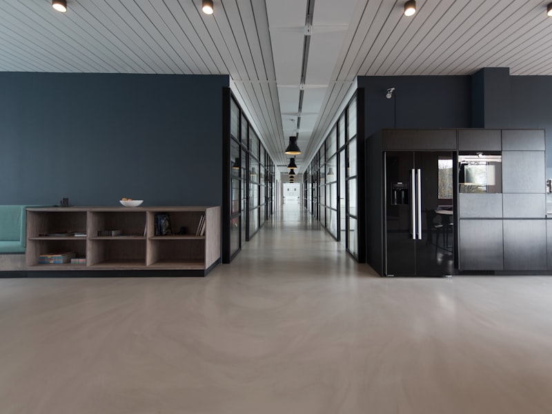 Bright modern office interior with polished concrete floor and glazed partitions