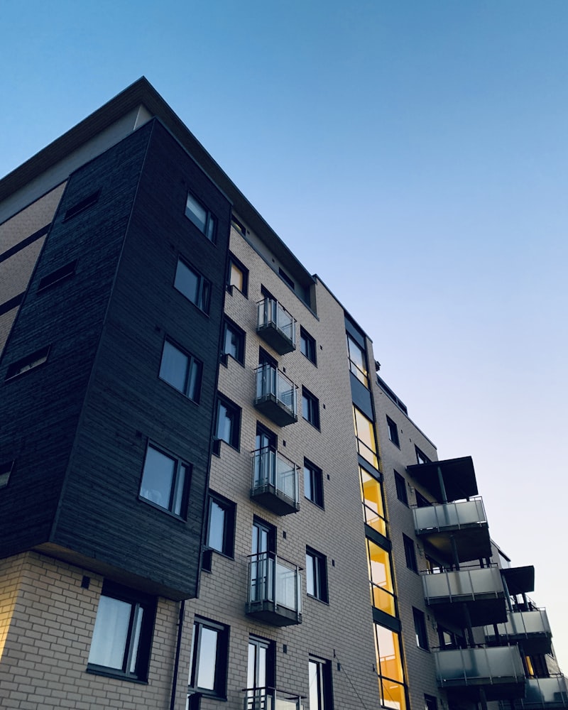 Completed modern apartment building with grey brick and amber-glass accents