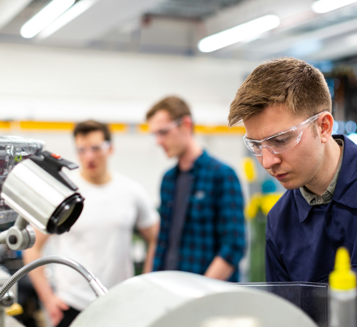 A licensed RapidFix technician in safety glasses focused on an electrical repair