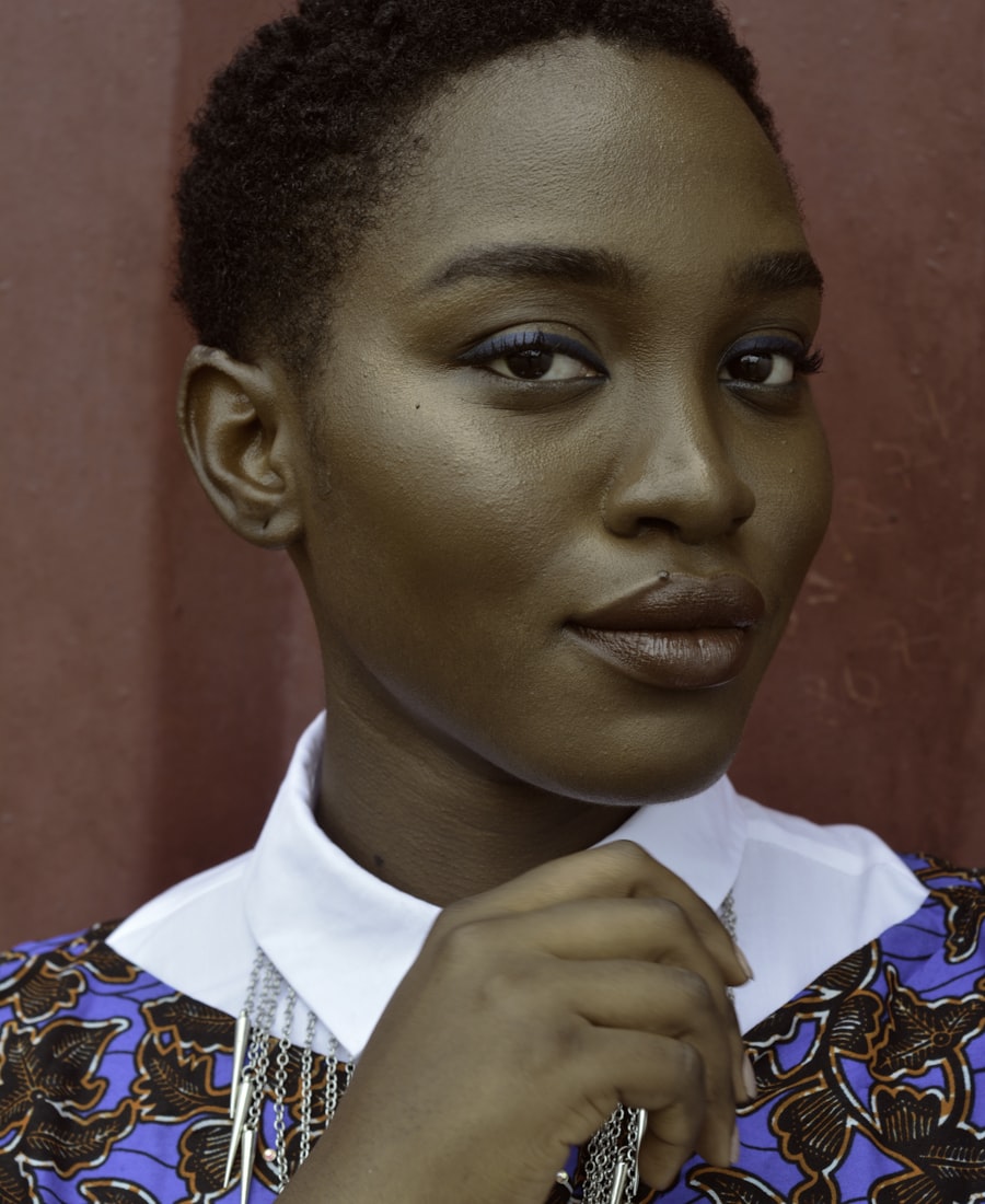 Portrait of Maya Okonkwo, lead photographer at Aperture and Co.