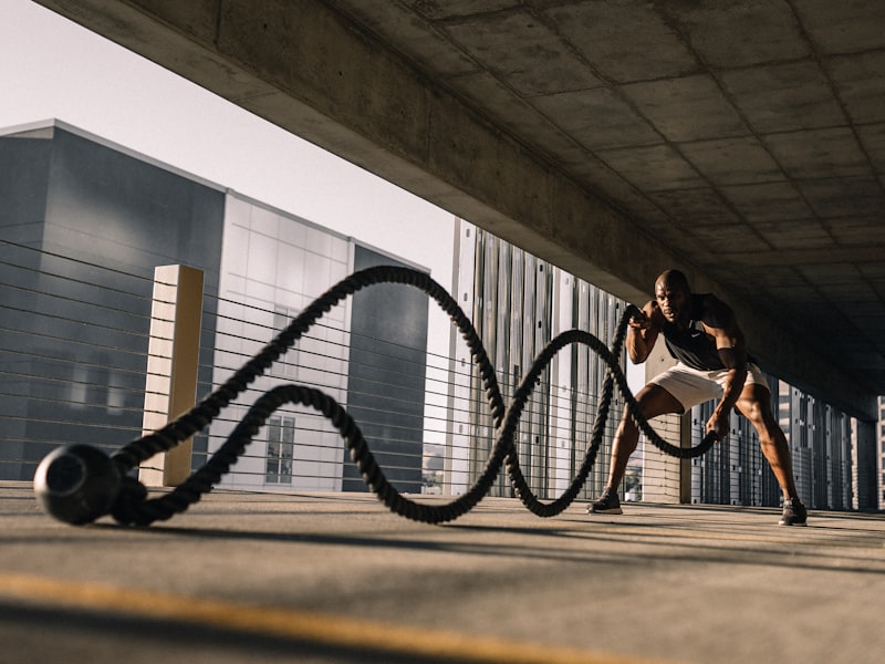 Athlete training with battle ropes outdoors