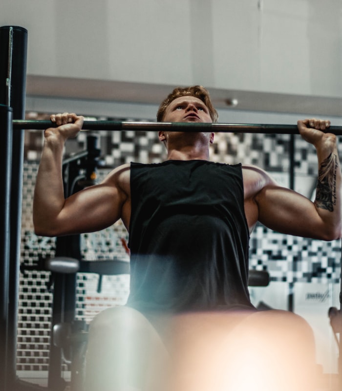 Client Daniel completing a pull-up at the rack