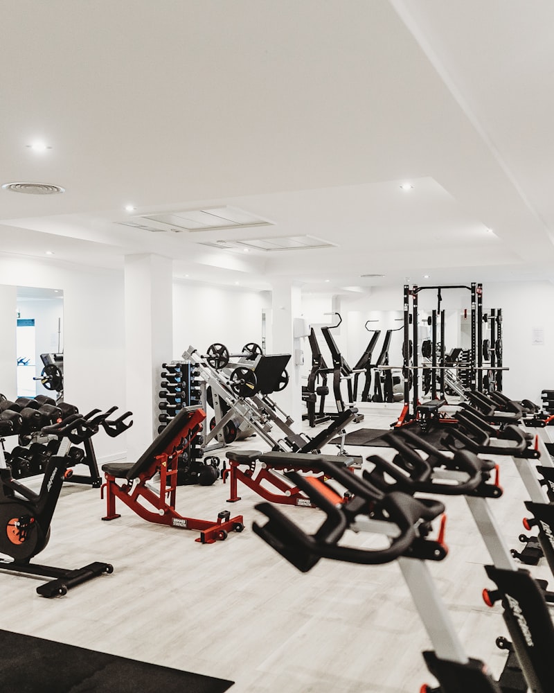Bright strength-training area lined with machines and benches