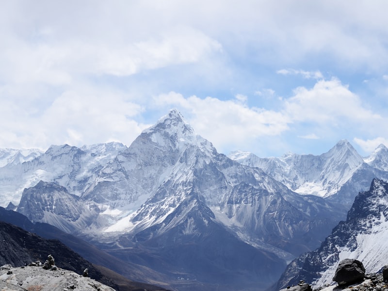 Sharp snow-capped Himalayan peak rising above a glaciated valley
