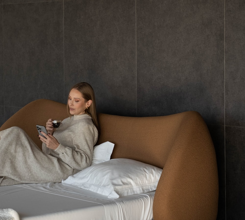 Woman relaxing with a coffee while checking her phone