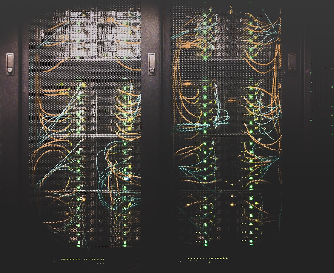 Rows of illuminated server racks with fibre optics in a Northpeak edge data centre