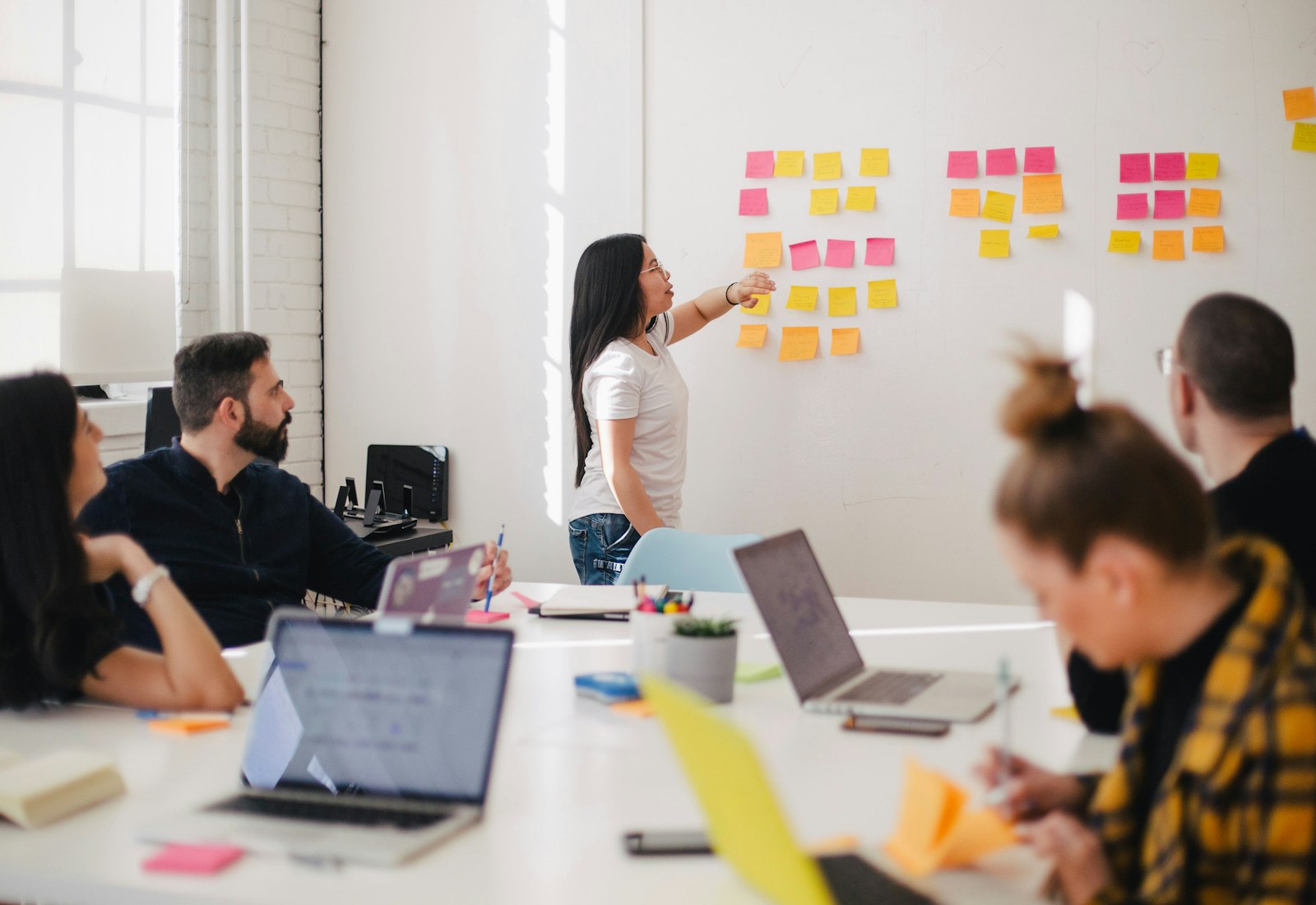 Risefold strategists mapping a campaign with colourful sticky notes in a bright studio
