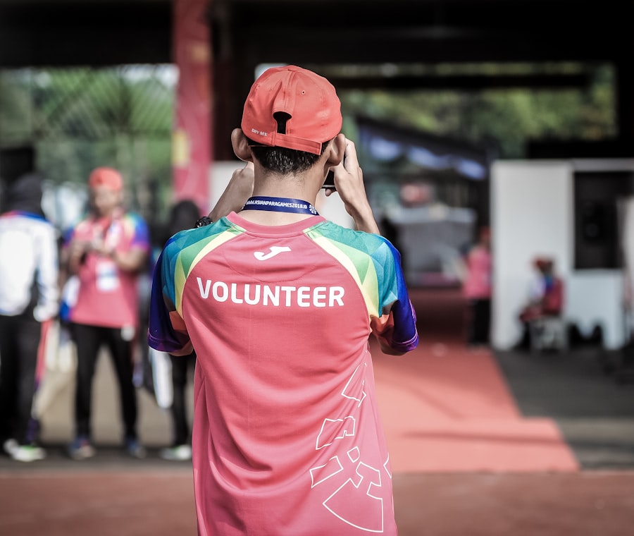 A volunteer in a bright team jersey at a community gathering