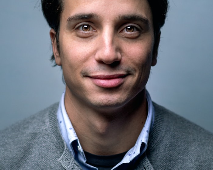 James, a man with a warm gentle smile, photographed in soft light