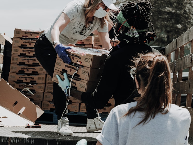 Volunteers loading boxes of food at a community outreach event