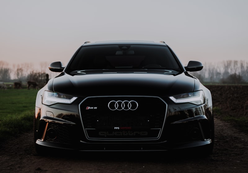 Black 2020 Audi RS 6 Avant, front view in open countryside