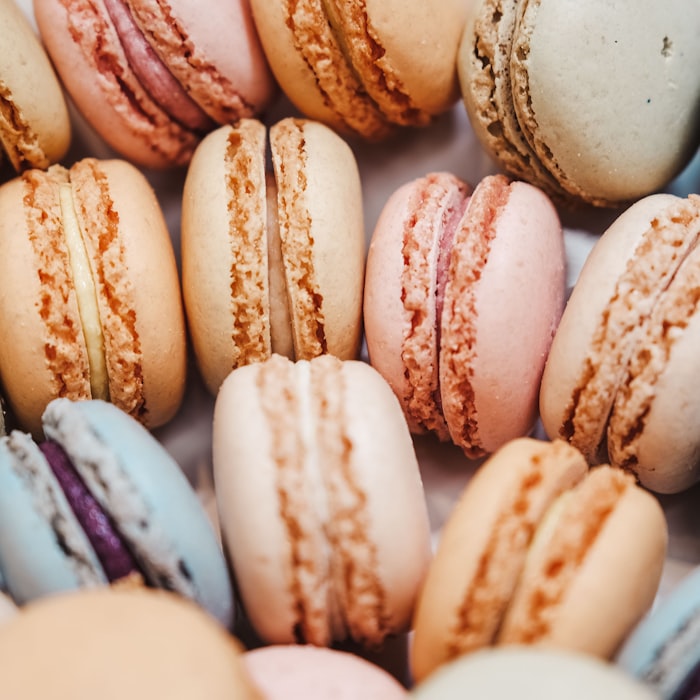 Rows of pastel French macarons in assorted flavors