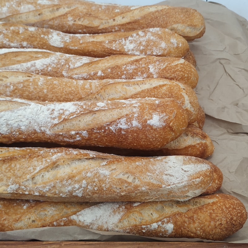 Freshly baked golden baguettes dusted with flour