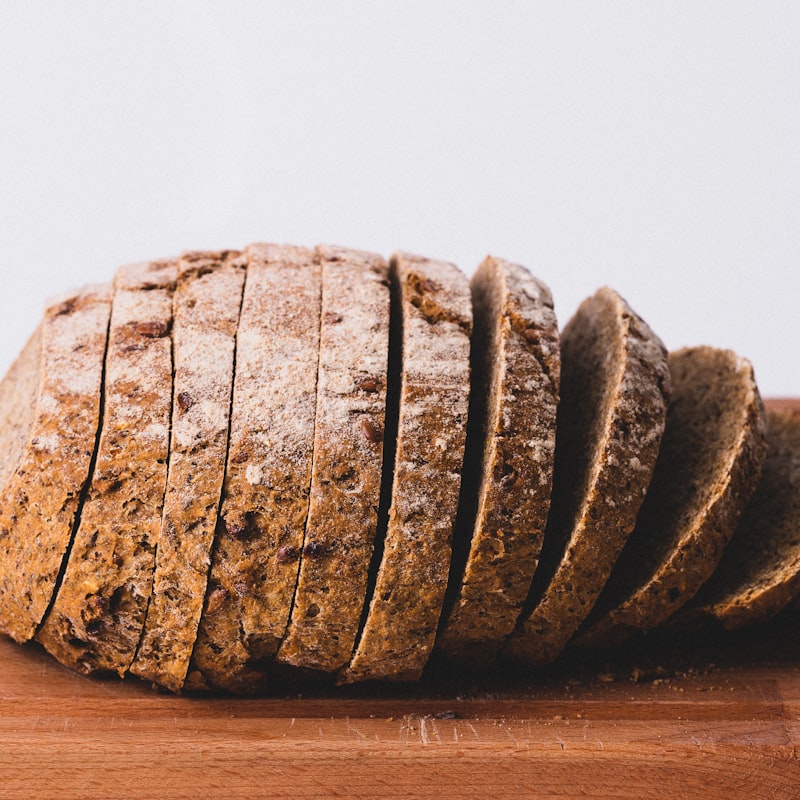 Sliced multigrain sourdough loaf on a wooden board
