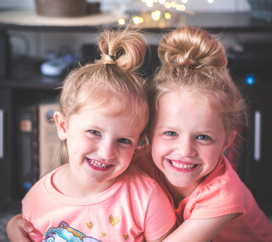 Two happy young friends hugging and smiling at preschool