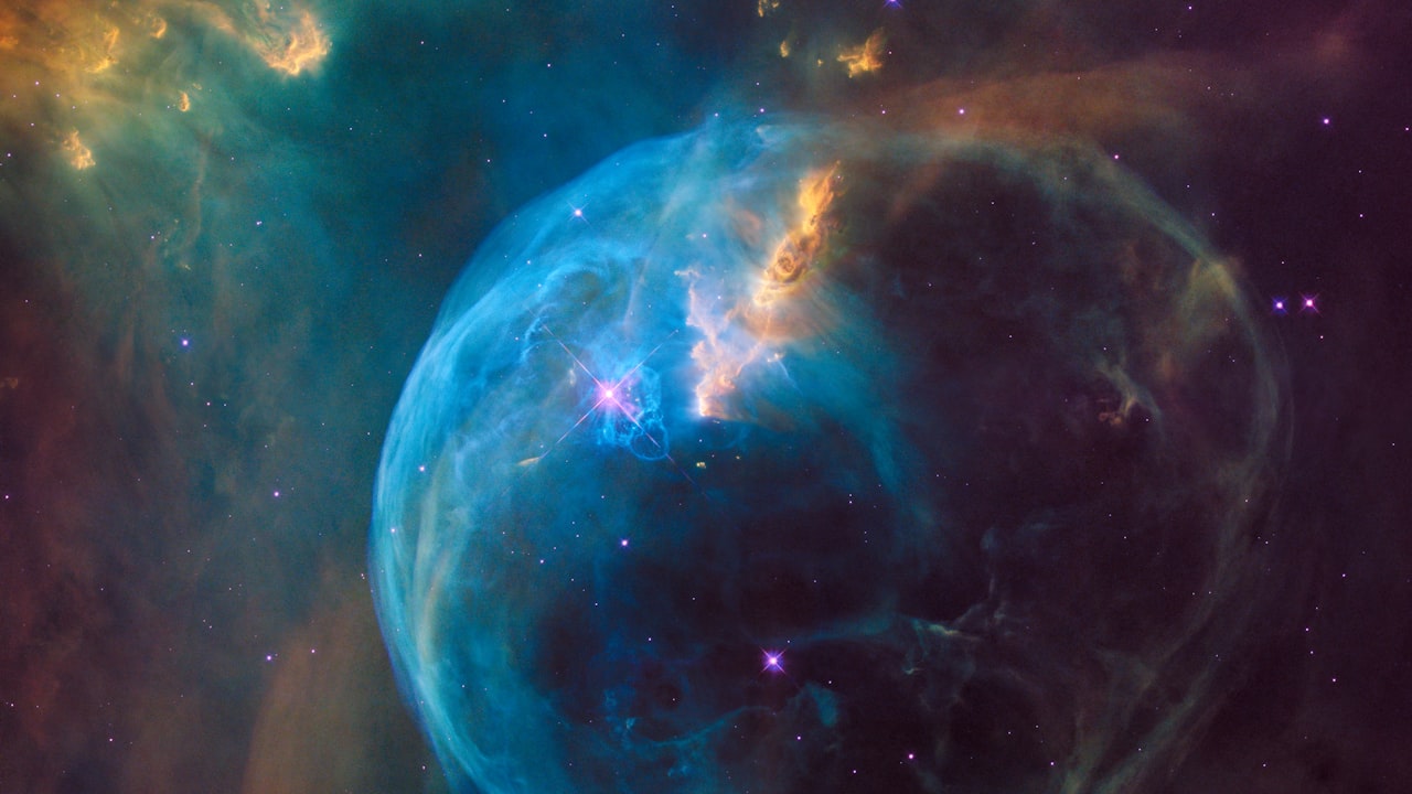 A luminous magenta-and-cyan nebula glowing across deep space in AETHERFALL.