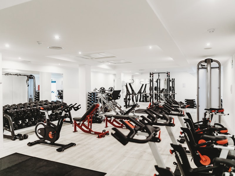 Bright performance gym fitted with free weights, racks and conditioning machines