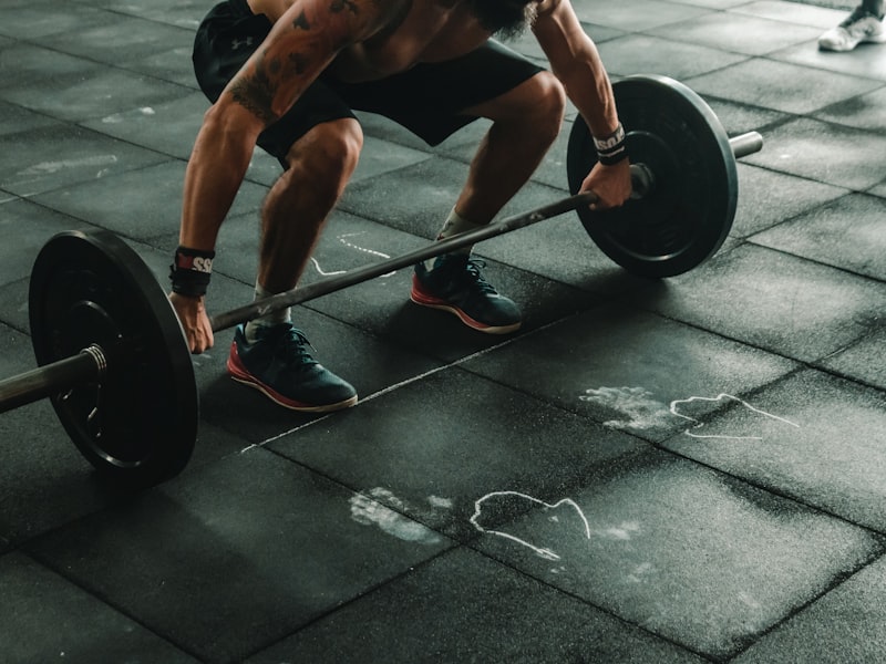 An athlete performing a barbell lift during a strength and conditioning session