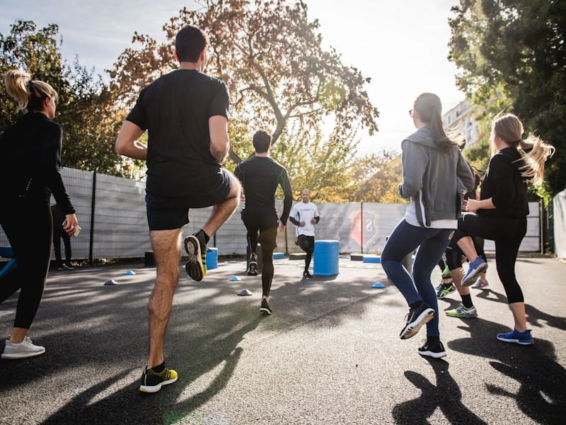 A group of runners powering through golden morning light on race day
