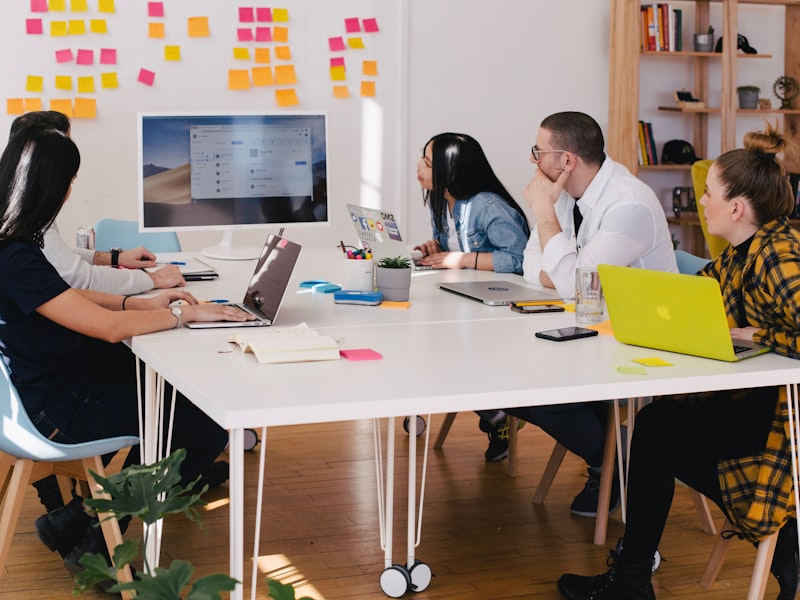 A hiring team reviewing shortlisted candidates together in a bright meeting room