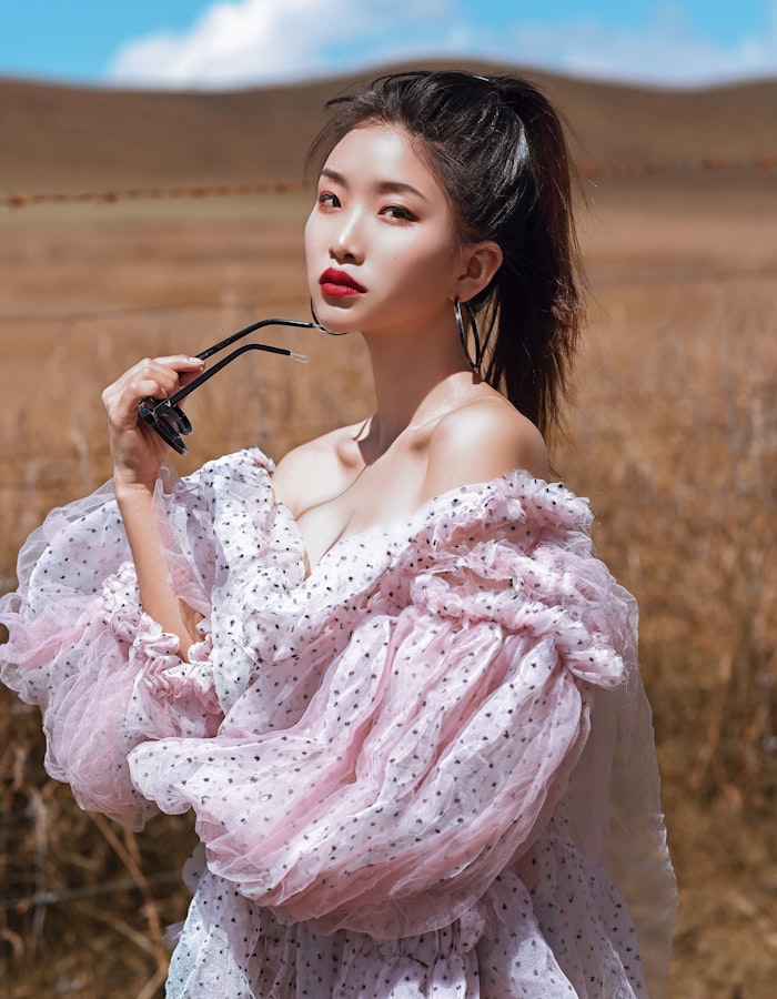 Model wearing a soft blush mohair-blend knit with a ruffled neckline