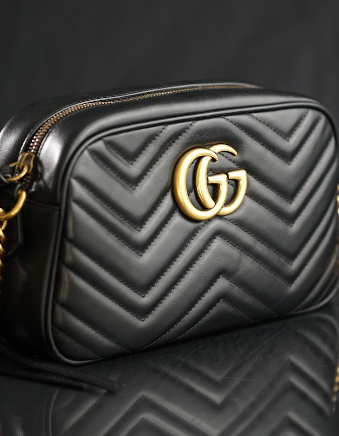A quilted black leather shoulder bag with a gold clasp