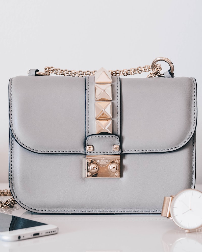 A soft grey quilted leather handbag on a pale surface