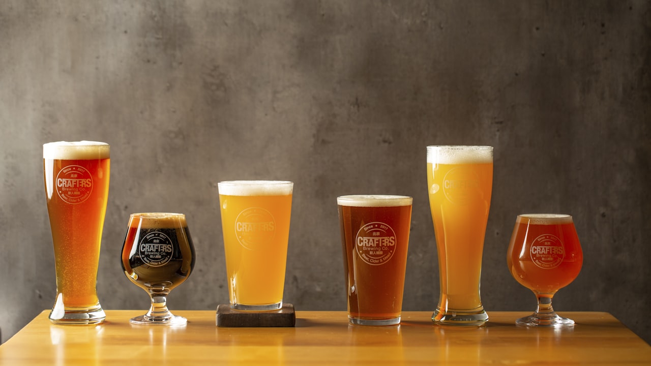 A flight of six Ironwood beers lined up on the taproom bar, from pale pilsner to dark stout