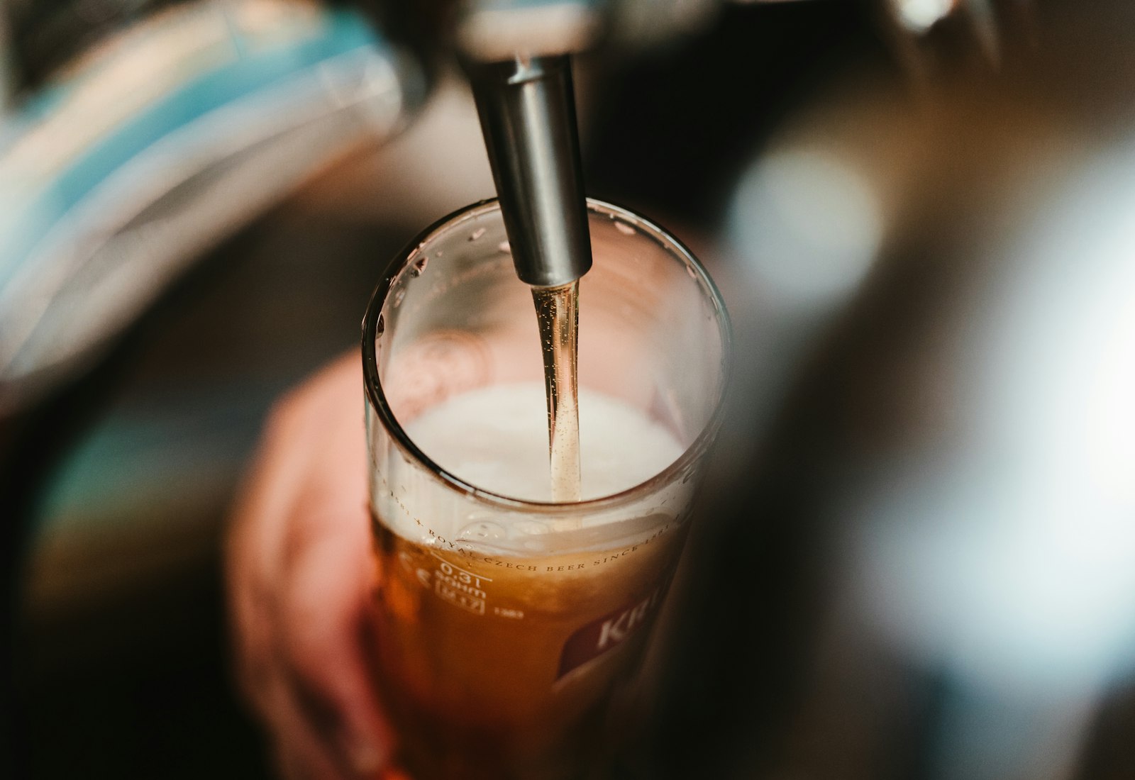 A fresh beer being poured from the tap into a glass at the Ironwood taproom bar
